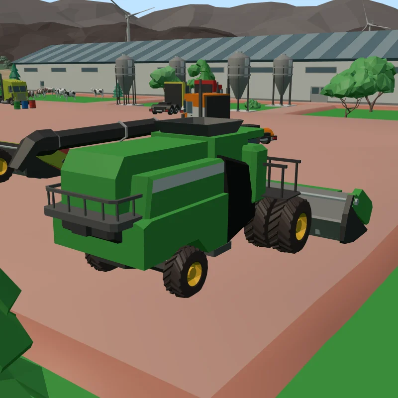 A green combine harvester parked in the machine yard, with trucks and grain silos behind it.